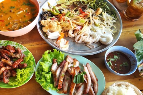 pasta with vegetables near meat with cabbage and stewed food in bowl